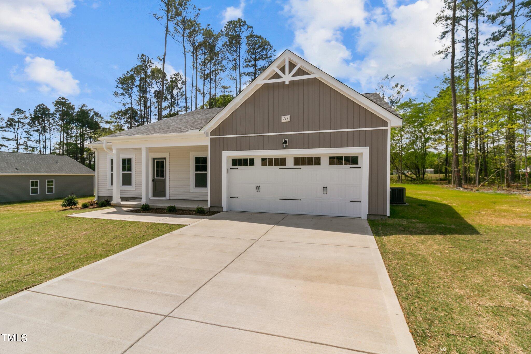 111 Regis Lane Coats, NC 27521 - Photo 3 of 36 a view of house with garden