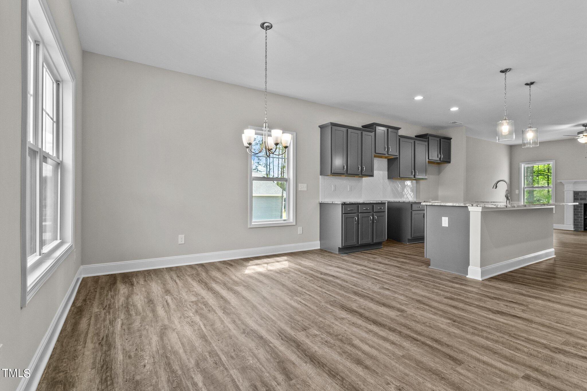 111 Regis Lane Coats, NC 27521 - Photo 6 of 36 a view of kitchen and kitchen with wooden floor