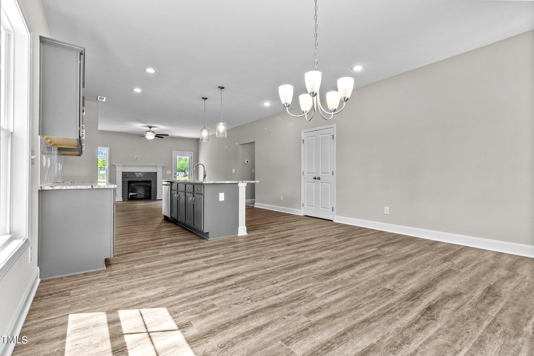 111 Regis Lane Coats, NC 27521 - Photo 7 of 36 a view of a kitchen with a sink a refrigerator and a fireplace