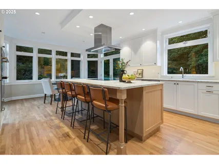 a dining hall with stainless steel appliances granite countertop a granite counter tops and a view of living room
