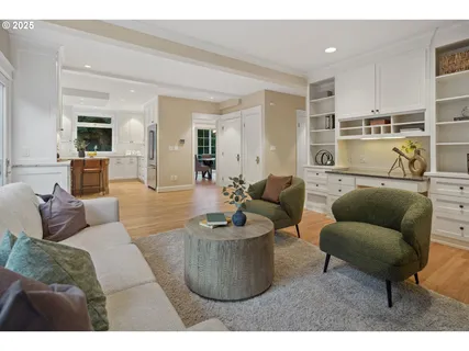 a living room with furniture flowerpot and a chandelier