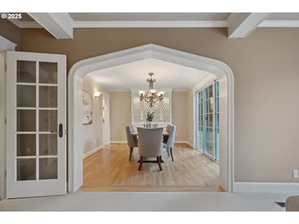 a view of a dining room with furniture and a chandelier