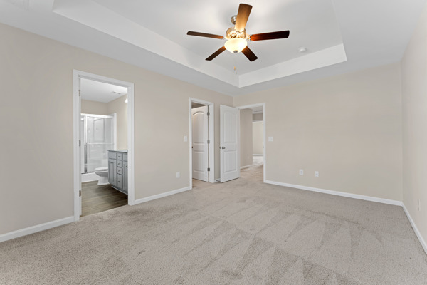 249 Samuel Street Pendleton, SC 29670 - Photo 5 of 33 This primary bedroom features plush carpeting and a tray ceiling, offering a serene personal retreat.
