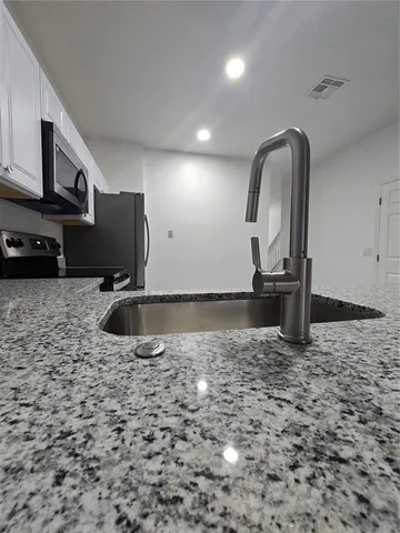 a view of a refrigerator in kitchen