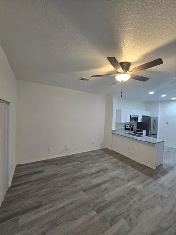 a view of kitchen with sink and wooden floor