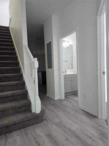 a view of entryway and hall with wooden floor