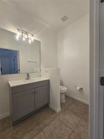 a bathroom with a double vanity sink and a toilet