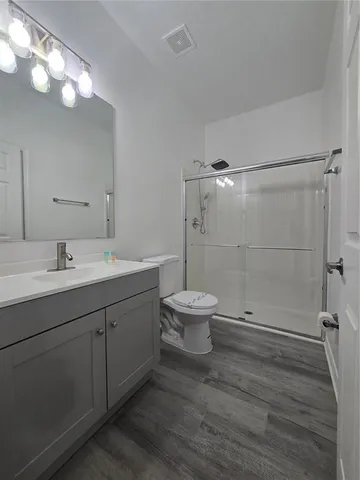 a bathroom with a double vanity sink toilet and shower