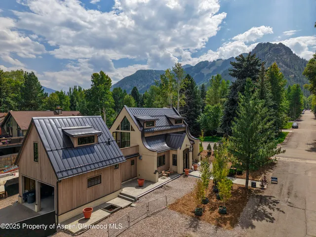 a kitchen with a sink and chairs