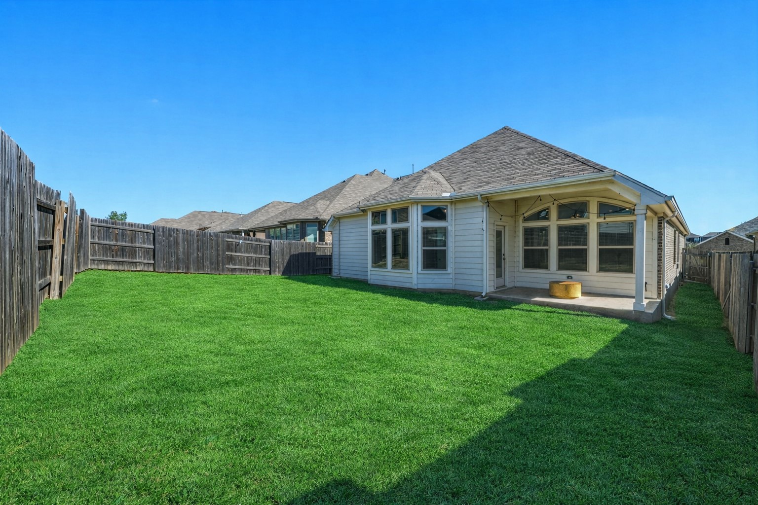 918 Leadtree Loop Buda, TX 78610 - Photo 19 of 27 Rear view of house featuring a fenced backyard and a patio area