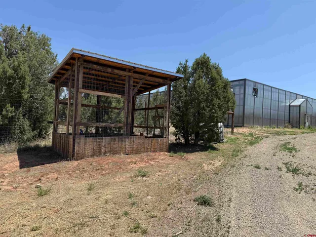 a view of a house with wooden fence