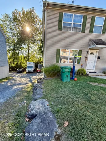 a backyard of a house with yard and outdoor seating