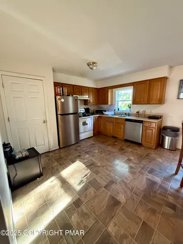a kitchen with a refrigerator and a stove