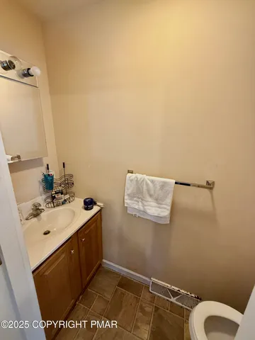 a bathroom with a sink a toilet and mirror