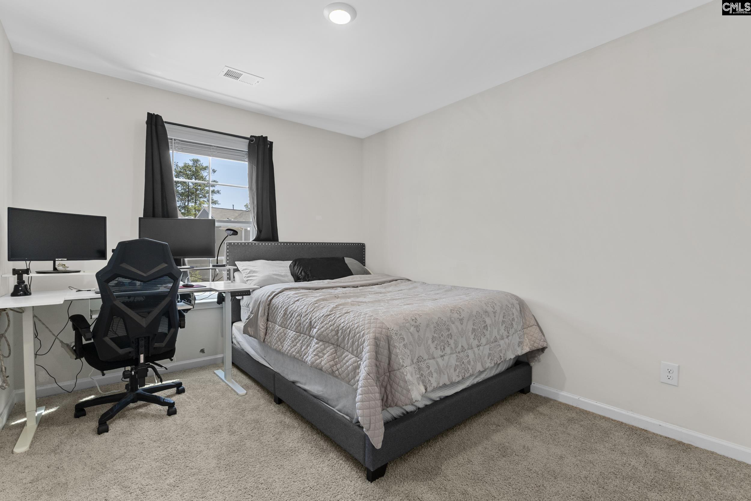 2097 Elmridge Road Columbia, SC 29209 - Photo 8 of 9 a bedroom with a bed and a desk
