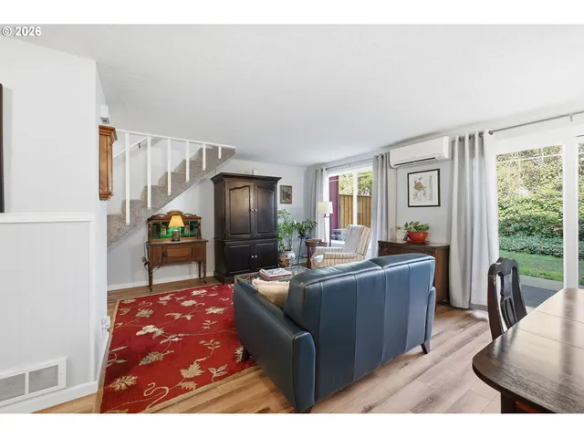 a living room with furniture a large window and a flat screen tv