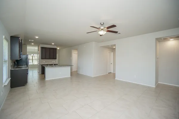 a large kitchen with stainless steel appliances a sink a stove and cabinets