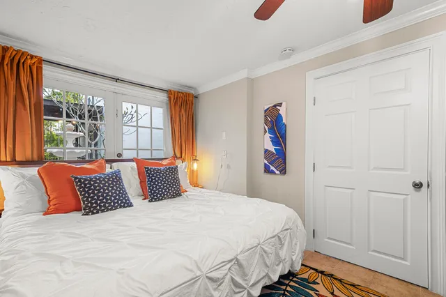 a bedroom with a large bed and a chandelier