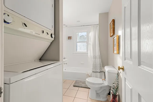 a spacious bedroom with a bed and wooden floor