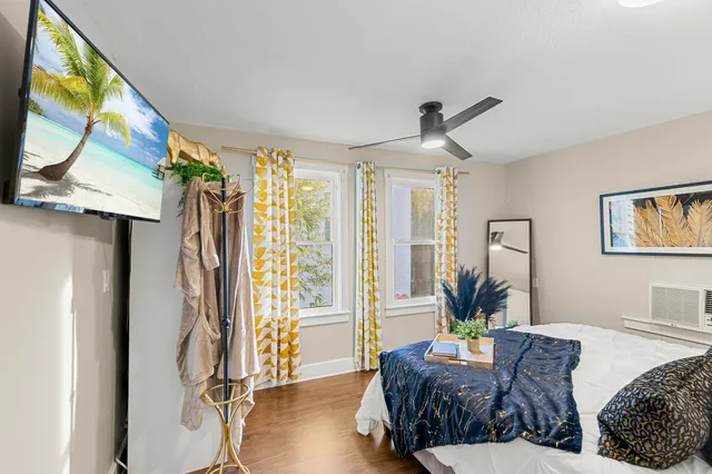 a bed room with two bed and a painting on the wall