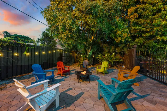 a backyard of a house with outdoor seating