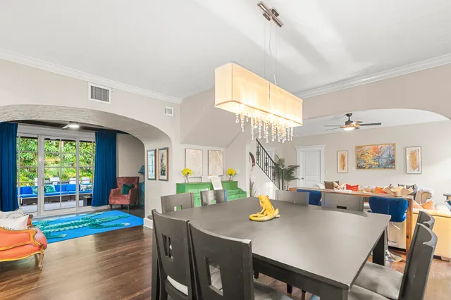 a living room with furniture a fireplace and a large window
