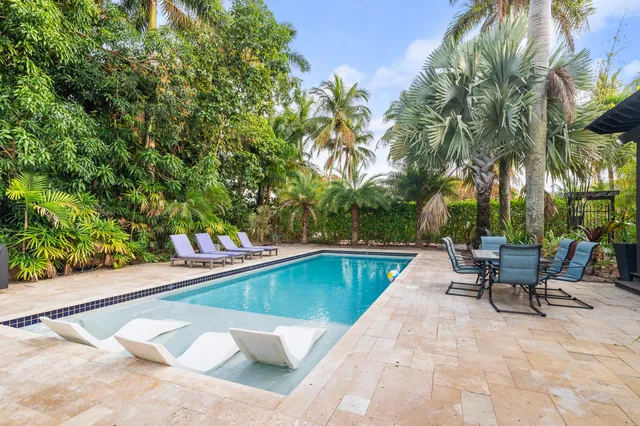 a bed sitting in a bedroom next to a large window
