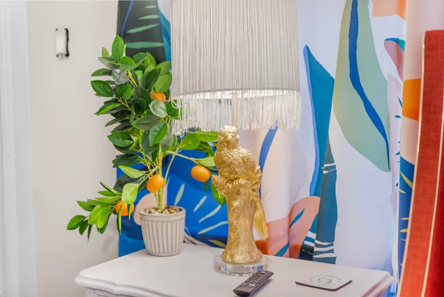 a vase of flowers besides of a table with six mirrors