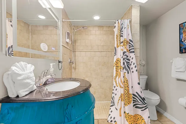 a large bed sitting in a bedroom next to a window