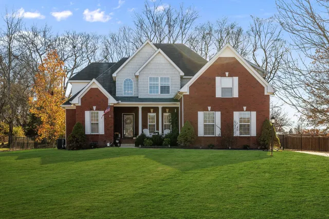 a front view of house with yard and green space
