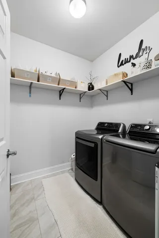 a bedroom with a bed painting on wall and a large window
