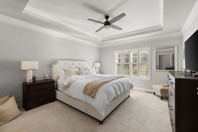 a bedroom with a bed and a chandelier