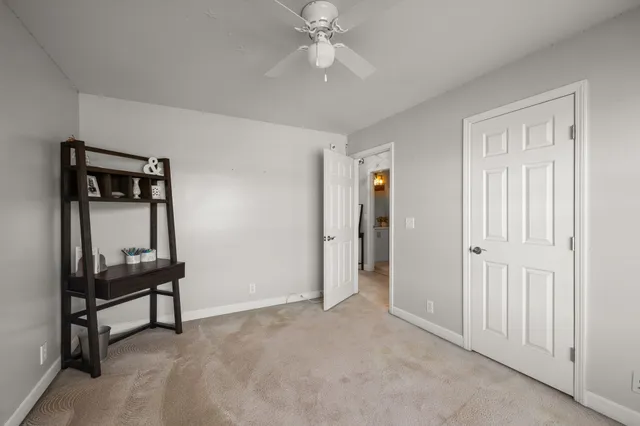 a bedroom with a bed a couch and a window