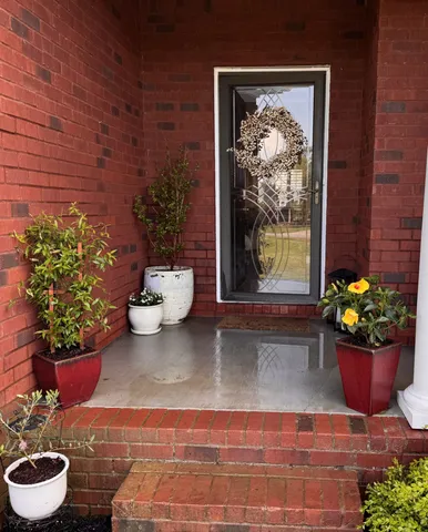 a view of a entryway with flower pots