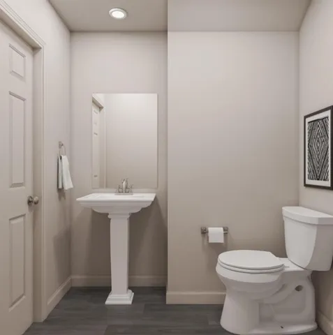 a bathroom with a sink toilet and a mirror