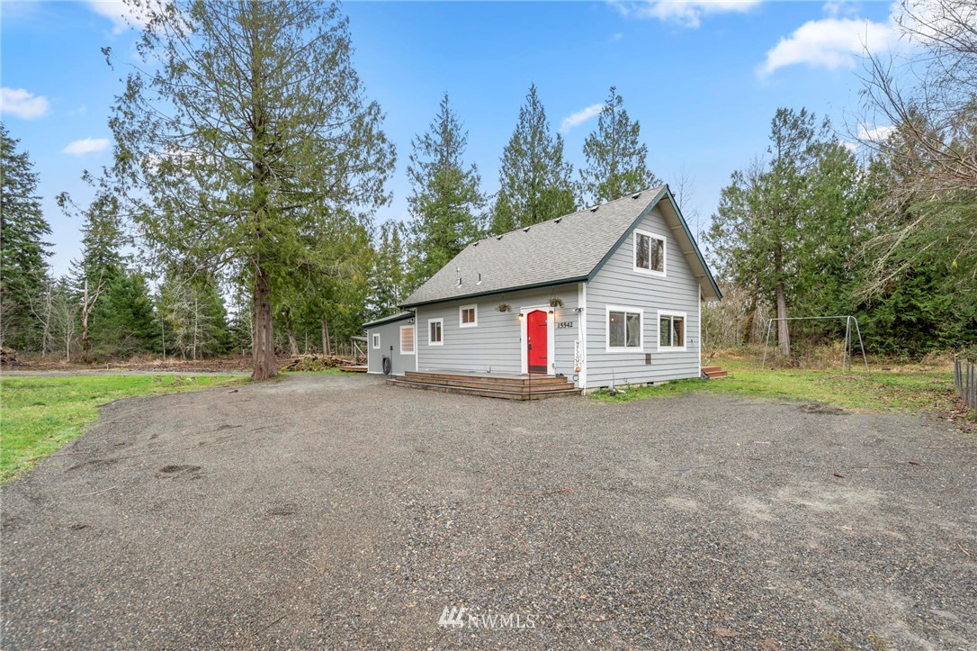 15542 Runyon Road Southeast Rainier, WA 98576 - Photo 1 of 23 a view of a house with a yard and large trees