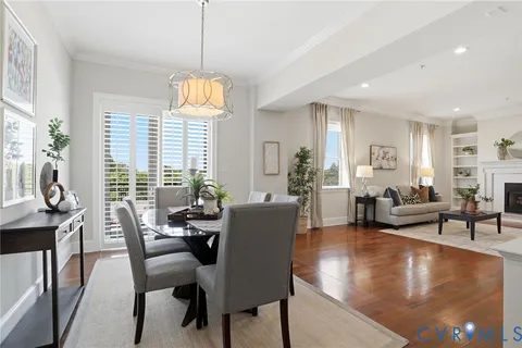 a living room with fireplace furniture and a large window