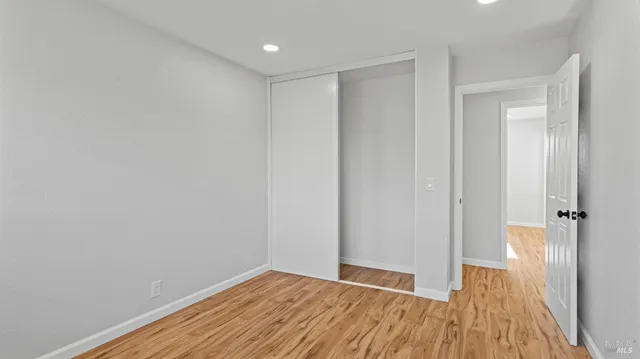 a view of a room with wooden floor