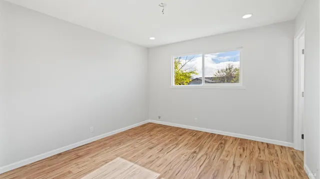 a view of room with wooden floor and window