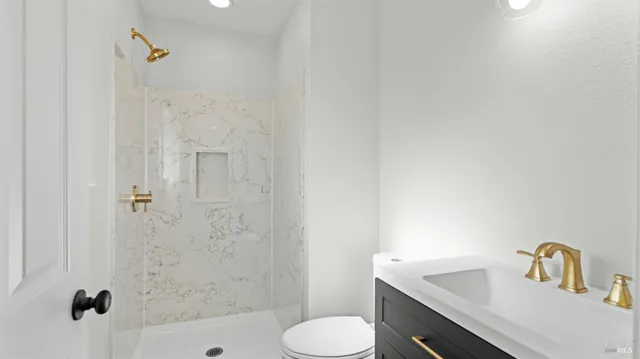 a bathroom with a sink toilet and shower