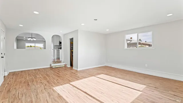 a view of a livingroom with a dinning area hardwood floor and staircase