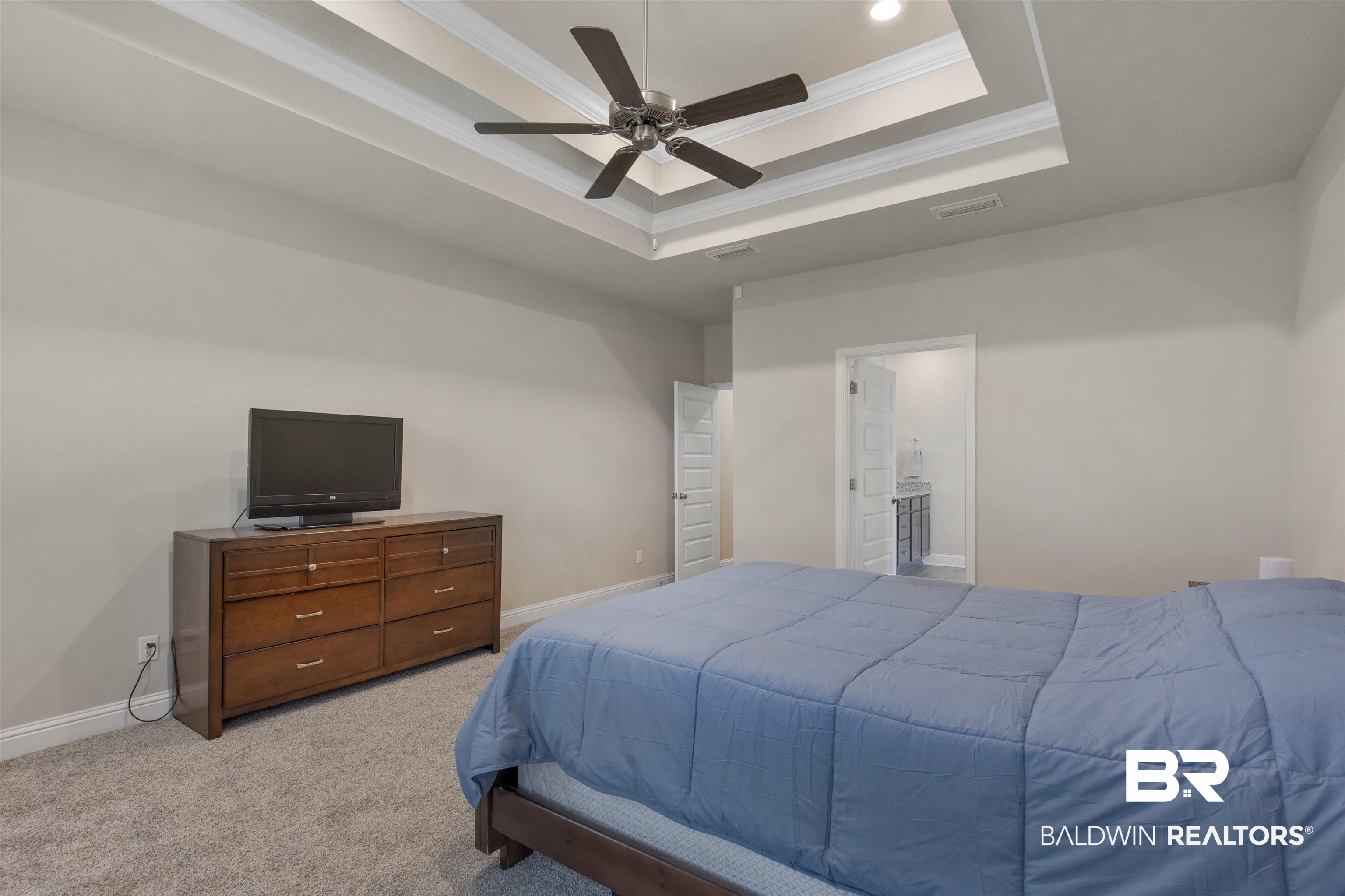 2345 Laurel Street Semmes, AL 36575 - Photo 13 of 31 Bedroom with a tray ceiling, light colored carpet, ornamental molding, ceiling fan, and recessed lighting