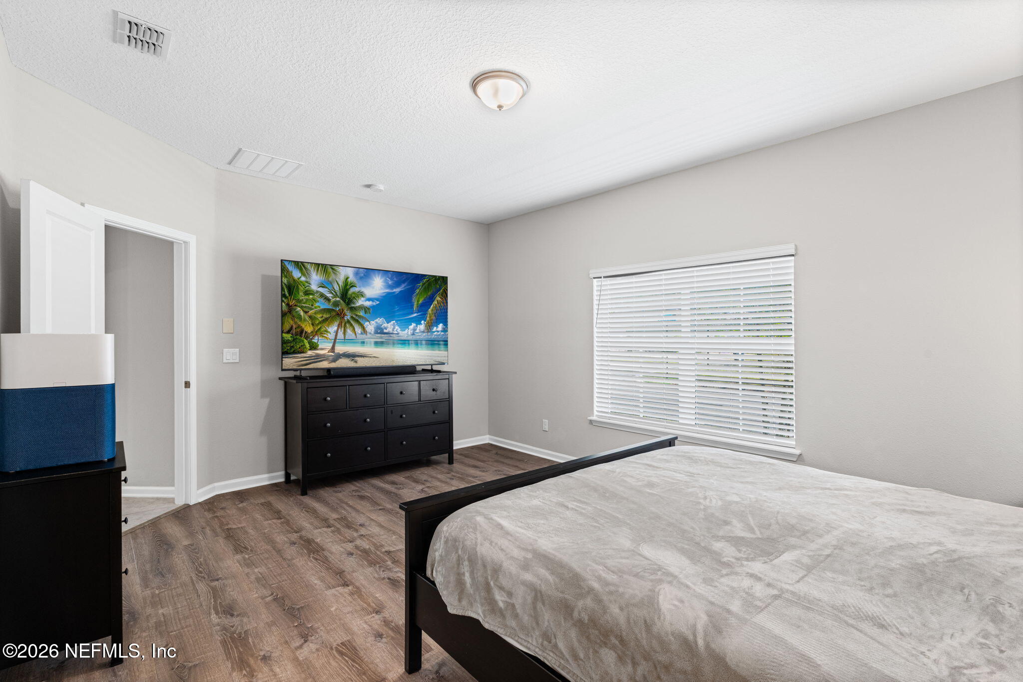 75209 Chelsea Gdn Way Yulee, FL 32097 - Photo 14 of 33 a bedroom with a bed and a television