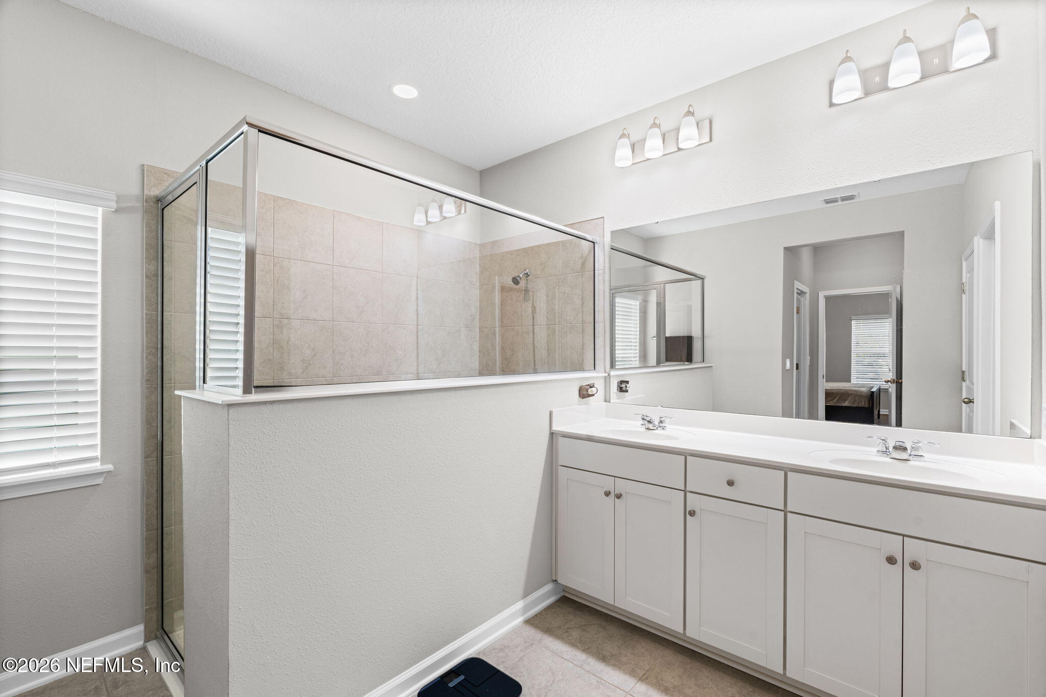 75209 Chelsea Gdn Way Yulee, FL 32097 - Photo 16 of 33 a bathroom with a double vanity sink and mirror