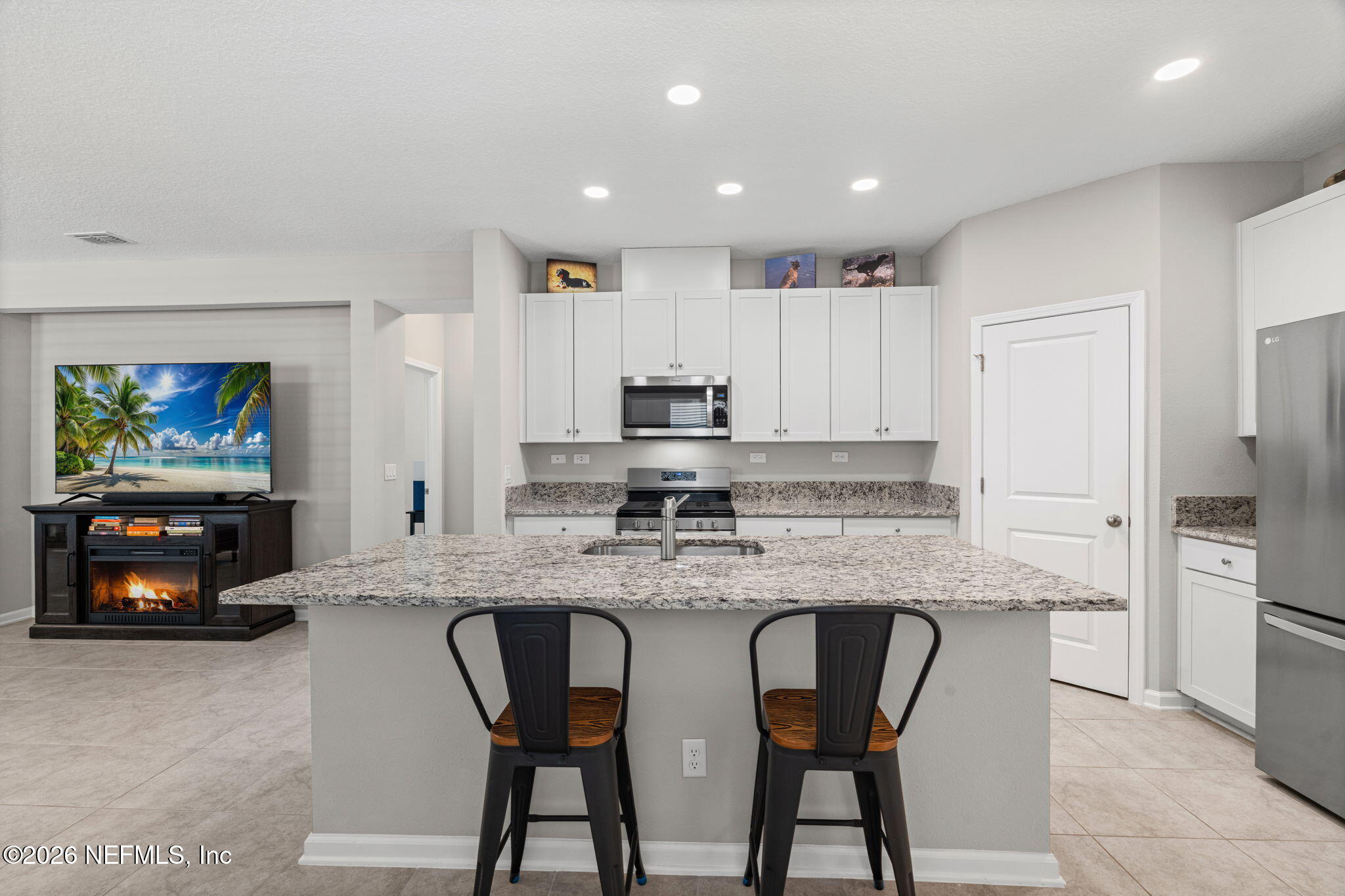 75209 Chelsea Gdn Way Yulee, FL 32097 - Photo 10 of 33 a kitchen with stainless steel appliances granite countertop a stove a sink and a refrigerator
