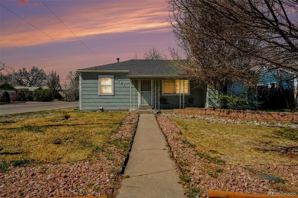 a view of a brick house with a yard