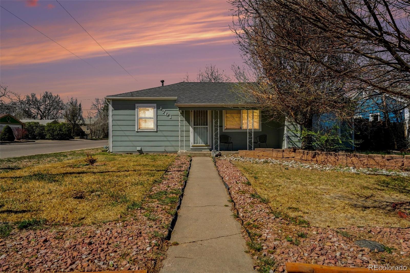 1701 Ironton Street Aurora, CO 80010 - Photo 1 of 23 a view of a brick house with a yard