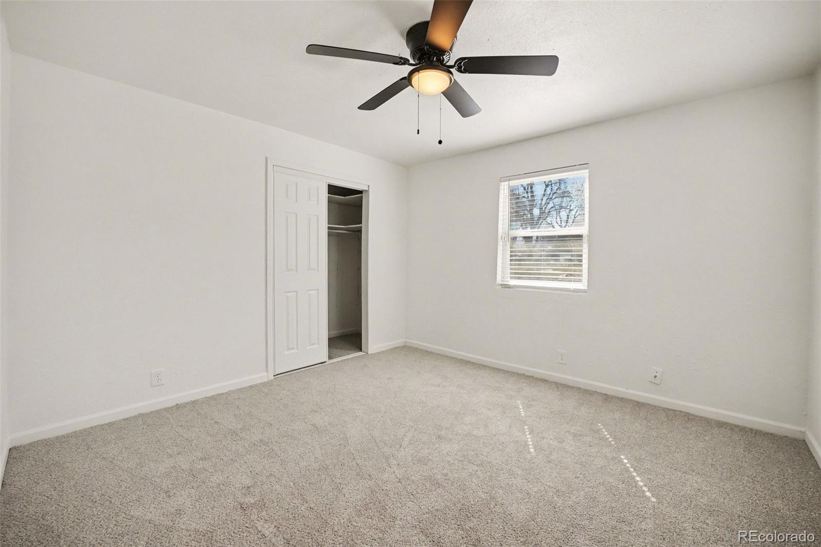 1701 Ironton Street Aurora, CO 80010 - Photo 13 of 23 an empty room with windows and fan