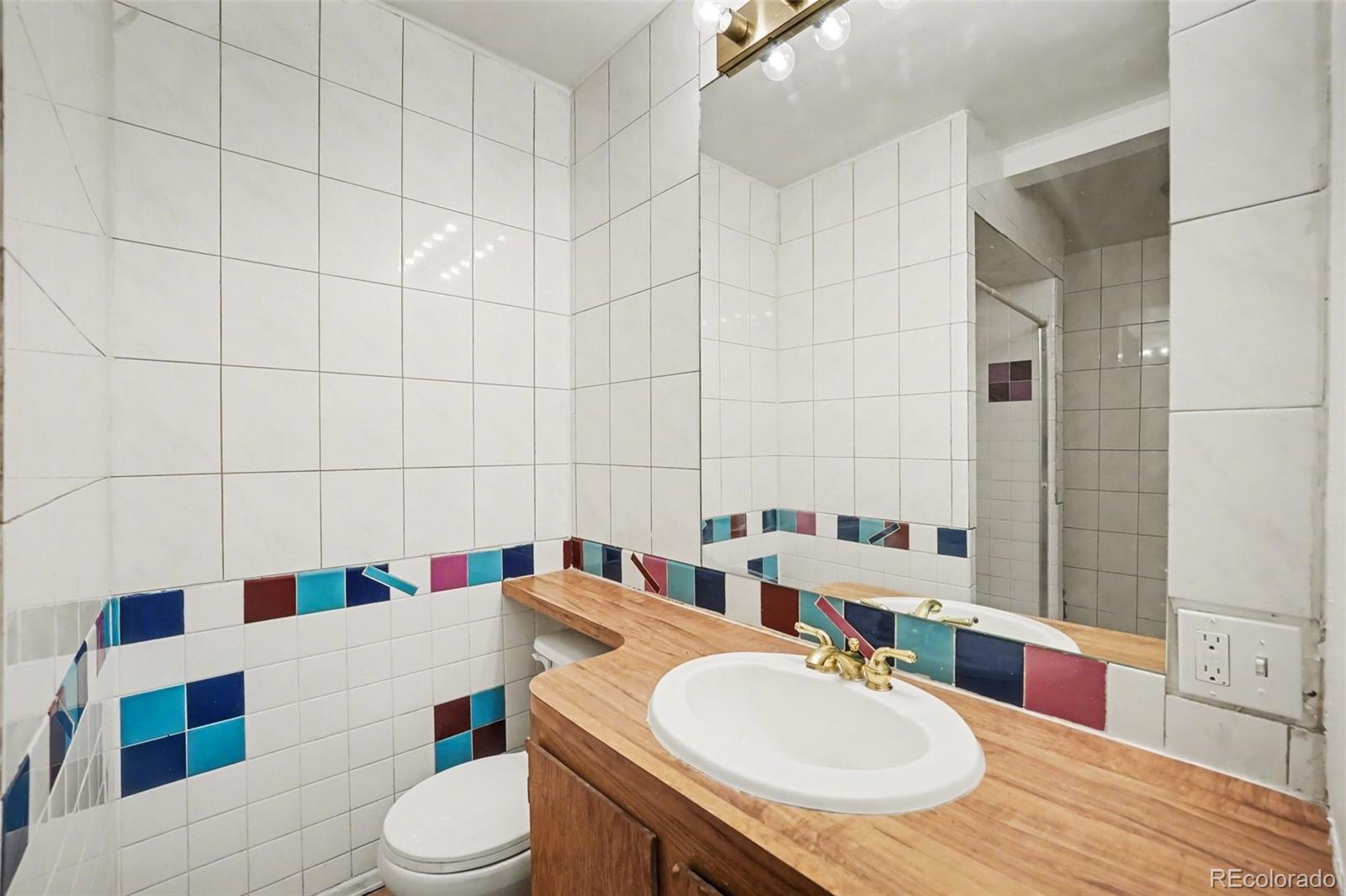 1701 Ironton Street Aurora, CO 80010 - Photo 14 of 23 a bathroom with a sink toilet and shower