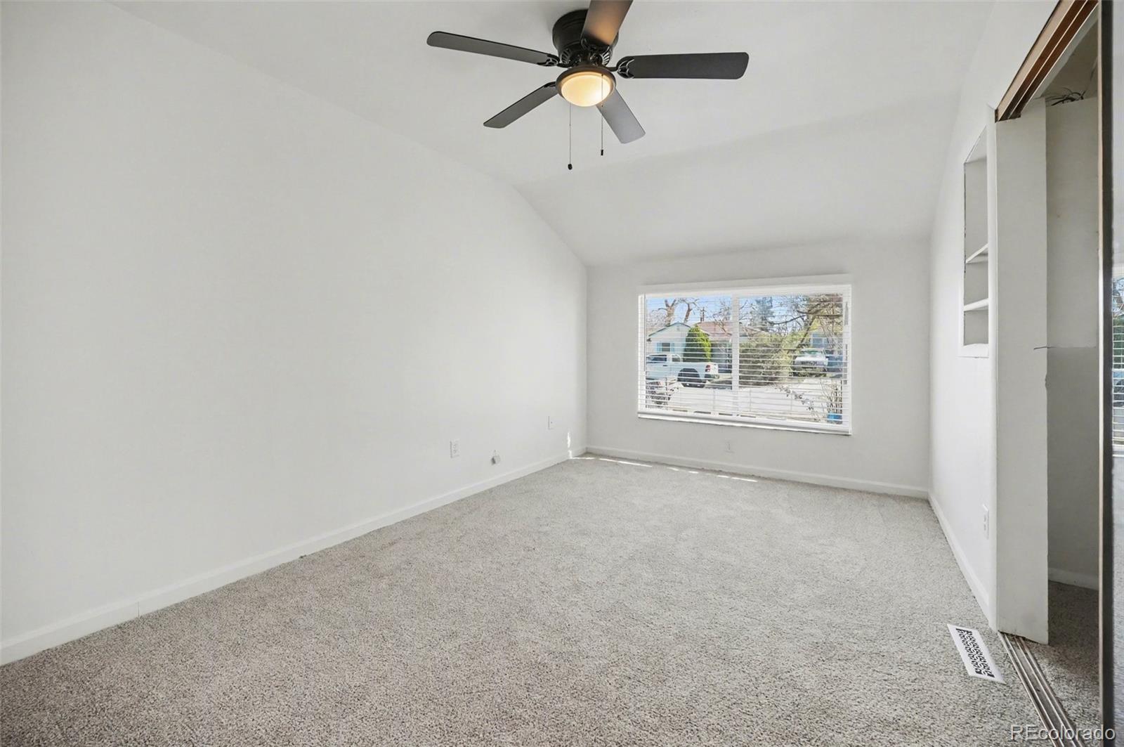 1701 Ironton Street Aurora, CO 80010 - Photo 16 of 23 an empty room with windows and ceiling fan